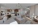 Open-concept living area with a large sofa, modern decor, and a view of the kitchen and staircase at 2631 Chance Canyon St, Henderson, NV 89044
