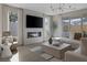 Bright living room featuring a modern fireplace, large TV, stylish decor, and expansive windows for natural light at 2631 Chance Canyon St, Henderson, NV 89044