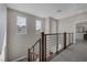 Upstairs landing showcasing a contemporary staircase with modern railing and ample natural light at 2631 Chance Canyon St, Henderson, NV 89044