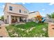 Backyard showcasing patio, playset with swings, and well-maintained lawn at 2672 Painted Mist Ct, Las Vegas, NV 89142
