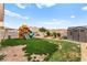 Spacious backyard featuring a large play structure, storage shed, and partial grass at 2672 Painted Mist Ct, Las Vegas, NV 89142