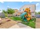 Backyard featuring a playset, tree, and rock landscaping, creating a Gathering-friendly outdoor space at 2672 Painted Mist Ct, Las Vegas, NV 89142