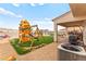 Inviting backyard with playset, swing set, patio, and well-maintained landscaping at 2672 Painted Mist Ct, Las Vegas, NV 89142