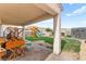 Expansive backyard featuring a covered patio, large playset, lush lawn, and storage shed at 2672 Painted Mist Ct, Las Vegas, NV 89142