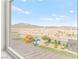 Window view of backyard features a playhouse, shed, desert, and mountain views at 2672 Painted Mist Ct, Las Vegas, NV 89142
