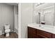 Bathroom featuring a vanity with sink, tiled floors, and a toilet with tub and shower at 2672 Painted Mist Ct, Las Vegas, NV 89142