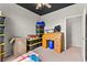 View of the bedroom, highlighting a stylish rolltop desk, storage bins, neutral paint, and carpet floors at 2672 Painted Mist Ct, Las Vegas, NV 89142