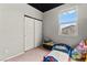 Bedroom featuring a toddler bed, closet, large window, neutral paint, and carpet flooring at 2672 Painted Mist Ct, Las Vegas, NV 89142