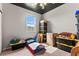 Bedroom featuring a playful toddler bed, storage bins, window views, and carpet flooring at 2672 Painted Mist Ct, Las Vegas, NV 89142