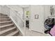 Hallway featuring staircase with a white banister, and tile flooring at 2672 Painted Mist Ct, Las Vegas, NV 89142