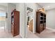 Hallway with carpet, gray walls, and built-in wooden cabinets provides space for storage solutions at 2672 Painted Mist Ct, Las Vegas, NV 89142