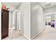 Bright hallway featuring neutral carpet and paint, with doorways leading to various rooms at 2672 Painted Mist Ct, Las Vegas, NV 89142