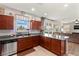 Well-lit kitchen with stainless steel dishwasher and backyard view at 2672 Painted Mist Ct, Las Vegas, NV 89142