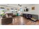 Comfortable living room featuring hardwood floors and a cozy seating area at 2672 Painted Mist Ct, Las Vegas, NV 89142