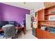 Bright office featuring a purple wall, desk, and organized shelves for functional and creative space at 2672 Painted Mist Ct, Las Vegas, NV 89142