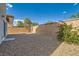 The backyard has rock groundcover, mature trees, and a block wall at 2728 Holmfault St, Henderson, NV 89044