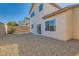 View of a backyard with gravel, block wall, and the exterior of the home at 2728 Holmfault St, Henderson, NV 89044