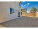 View of the back of a two story home and the backyard with gravel at 2728 Holmfault St, Henderson, NV 89044