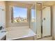 Bright bathroom featuring a soaking tub and separate glass shower at 2728 Holmfault St, Henderson, NV 89044