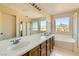 Bright bathroom with dual sinks, soaking tub and separate shower at 2728 Holmfault St, Henderson, NV 89044