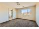 Comfortable bedroom with natural light, plush carpeting, and views of the surrounding landscape at 2728 Holmfault St, Henderson, NV 89044