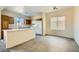 Bright kitchen featuring a breakfast bar, white appliances, and tile flooring at 2728 Holmfault St, Henderson, NV 89044