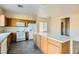 Well-lit kitchen with a large island, gas range, white appliances, and ample storage at 2728 Holmfault St, Henderson, NV 89044