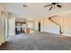 Open-concept living area featuring carpet flooring, ceiling fan, and access to the kitchen at 2728 Holmfault St, Henderson, NV 89044