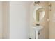 Compact powder room with pedestal sink, round mirror, and clean, minimalist design at 2728 Holmfault St, Henderson, NV 89044