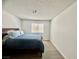 Cozy bedroom features modern floors, a comfortable bed, and a window offering natural light at 3151 Soaring Gulls Dr # 1023, Las Vegas, NV 89128