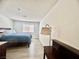 Bright bedroom featuring modern floors, a large bed, and a window providing natural light at 3151 Soaring Gulls Dr # 1023, Las Vegas, NV 89128