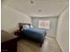 Cozy bedroom with a queen-sized bed, wood-look floor, and natural light at 3151 Soaring Gulls Dr # 1023, Las Vegas, NV 89128