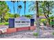 Desert Shores Villas Condominiums sign surrounded by lush landscaping and mature trees at 3151 Soaring Gulls Dr # 1023, Las Vegas, NV 89128
