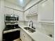 Modern kitchen with stainless steel appliances, quartz countertops, and ample cabinet space at 3151 Soaring Gulls Dr # 1023, Las Vegas, NV 89128