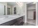 Bathroom featuring a double sink vanity with dark cabinets and bright countertop at 3165 Via Como, Henderson, NV 89044