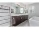 Elegant bathroom featuring double sinks, a soaking tub, and modern fixtures at 3165 Via Como, Henderson, NV 89044