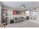 Bonus room featuring a sofa, sports memorabilia, and contemporary decor at 3165 Via Como, Henderson, NV 89044