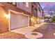 Exterior view of garages with illuminated exteriors, enhancing curb appeal at 3165 Via Como, Henderson, NV 89044
