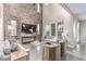 Bright living room with a soaring brick wall, modern decor, and an open, airy feel at 3165 Via Como, Henderson, NV 89044