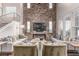 Spacious living room with a brick accent wall, modern furnishings, and abundant natural light at 3165 Via Como, Henderson, NV 89044
