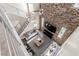 Overhead view of a modern living room featuring a brick wall, high ceilings, and ample seating at 3165 Via Como, Henderson, NV 89044