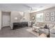 Living room featuring stairs, modern decor, a sectional sofa, and tile flooring at 3165 Via Como, Henderson, NV 89044