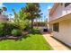 Well-maintained backyard with a lush green lawn, manicured landscaping, patio, and an outdoor grill area at 3341 Heavenly View Ct, Las Vegas, NV 89117