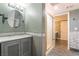 Cozy bathroom featuring a grey vanity with marble countertop, mosaic backsplash, and glass enclosed shower at 3341 Heavenly View Ct, Las Vegas, NV 89117