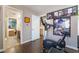 The bedroom includes an exercise bike, wood floors, and an adjacent bathroom and bedroom at 3341 Heavenly View Ct, Las Vegas, NV 89117