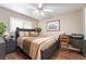 A bedroom with dark furniture and dark hardwood floors at 3341 Heavenly View Ct, Las Vegas, NV 89117
