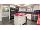 Kitchen featuring stainless steel appliances, white cabinetry, and red counter tops at 3341 Heavenly View Ct, Las Vegas, NV 89117