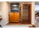 Custom wine storage with a beverage refrigerator and a rack for displaying wine bottles at 3341 Heavenly View Ct, Las Vegas, NV 89117