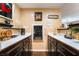 Custom wine bar with a beverage refrigerator and a dark wood cabinets at 3341 Heavenly View Ct, Las Vegas, NV 89117
