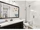 Modern bathroom with white subway tile shower and dark vanity with modern countertop at 352 Dandelion Brook Ct, Las Vegas, NV 89148